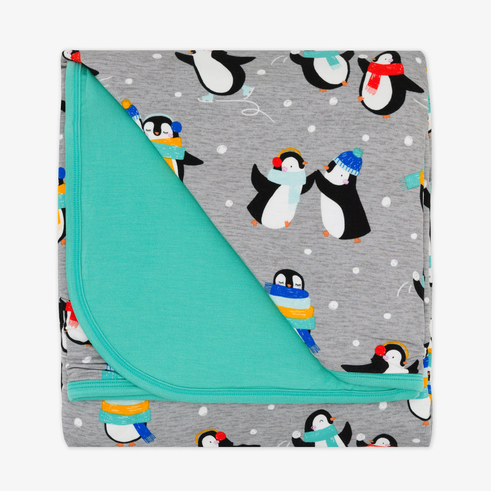 Flat lay image of a Penguin Party cloud blanket