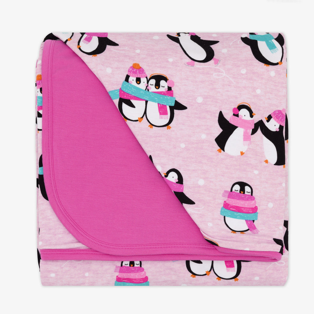 Flat lay image of a Pink Penguin Party blanket