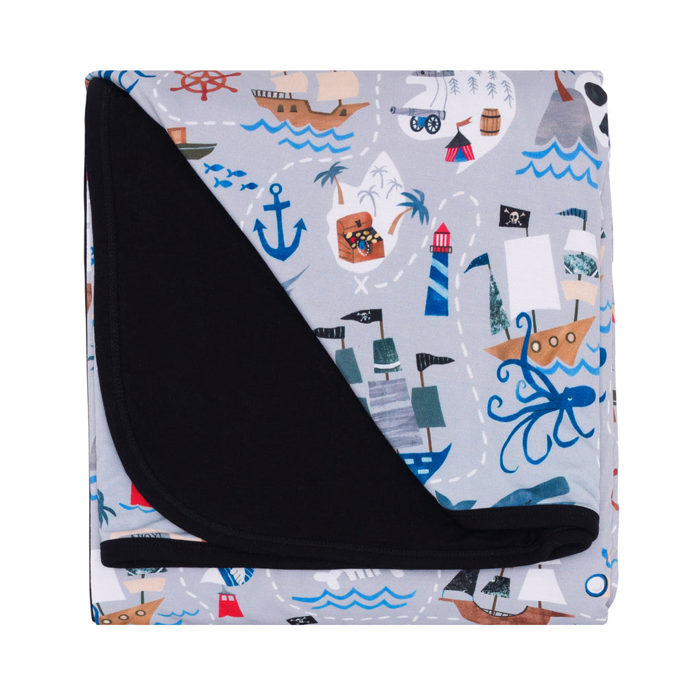 Flat lay image of the Pirate's Map Large Cloud Blanket® folded