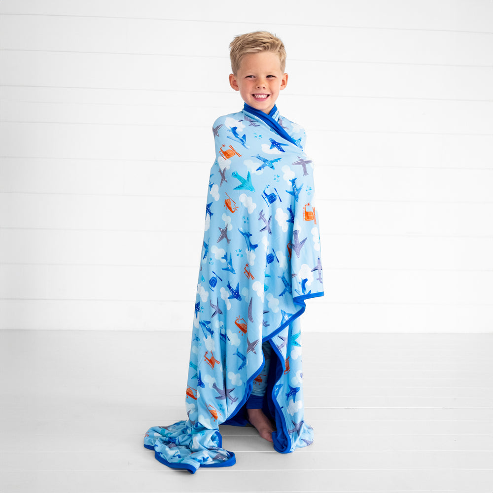 Child wrapped in a lets fly blanket