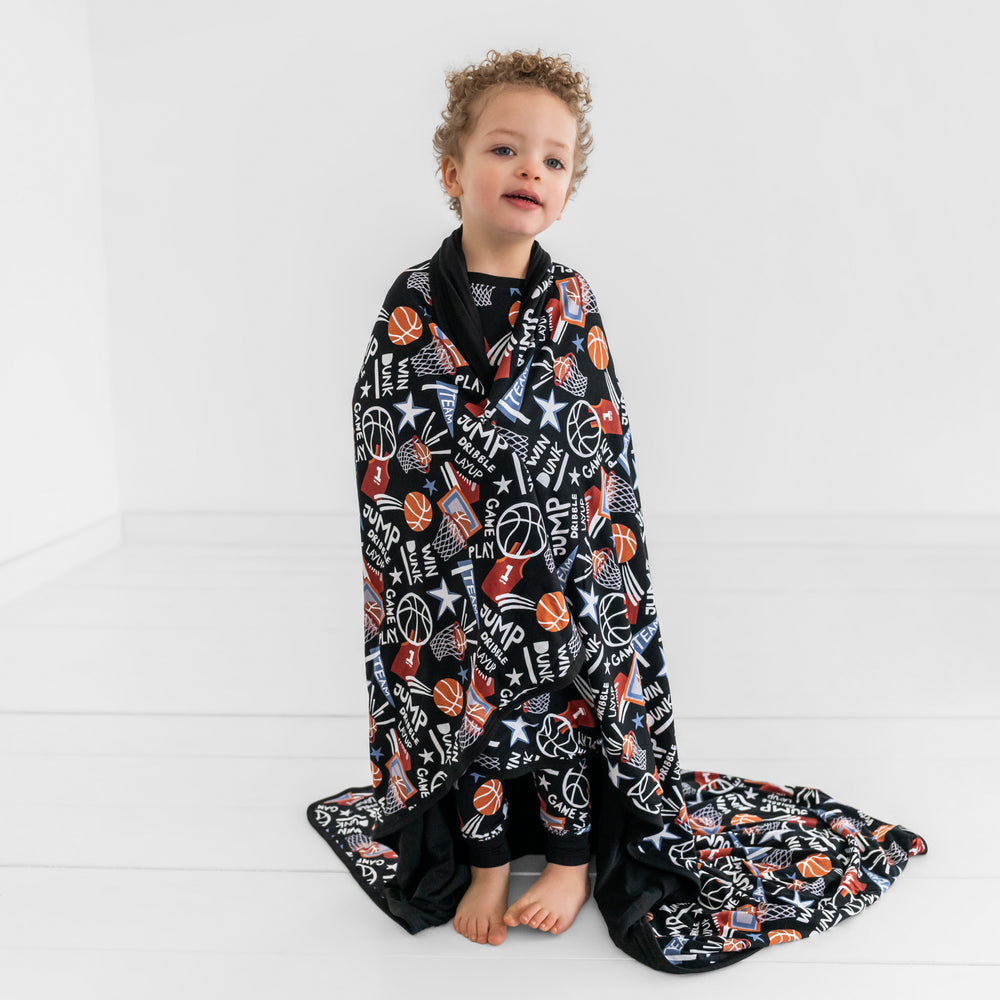 Child wrapped in the Black Slam Dunk Cloud blanket