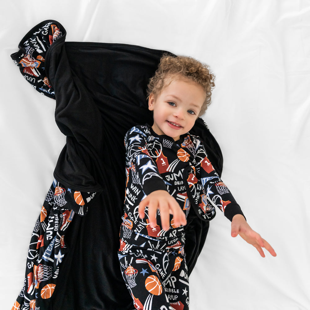 Child laying with the Black Slam Dunk Cloud blanket