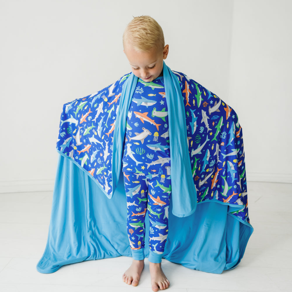 Child wrapped up in a Rad Reef large cloud blanket and wearing matching pajamas