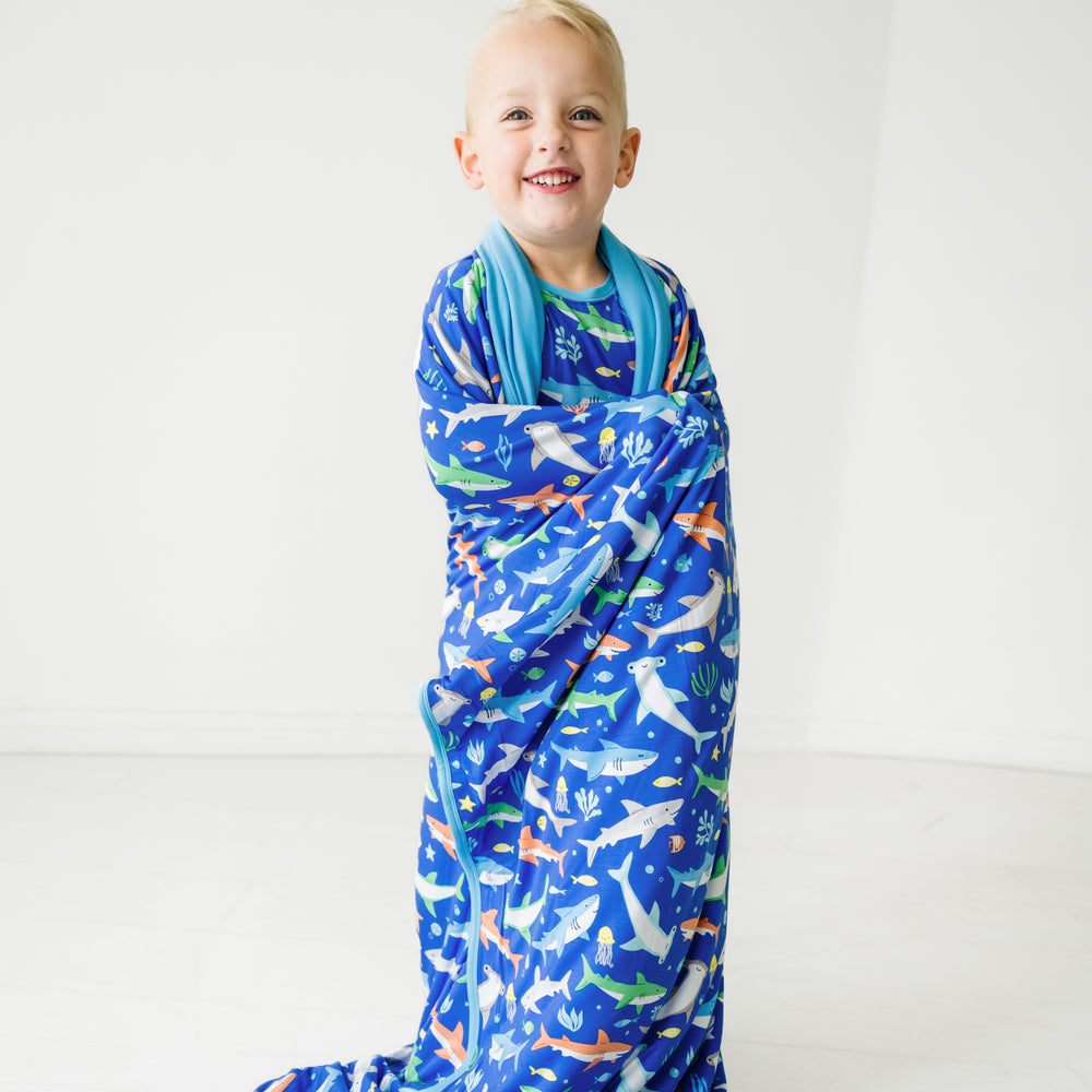 Child wrapped up in a Rad Reef large cloud blanket