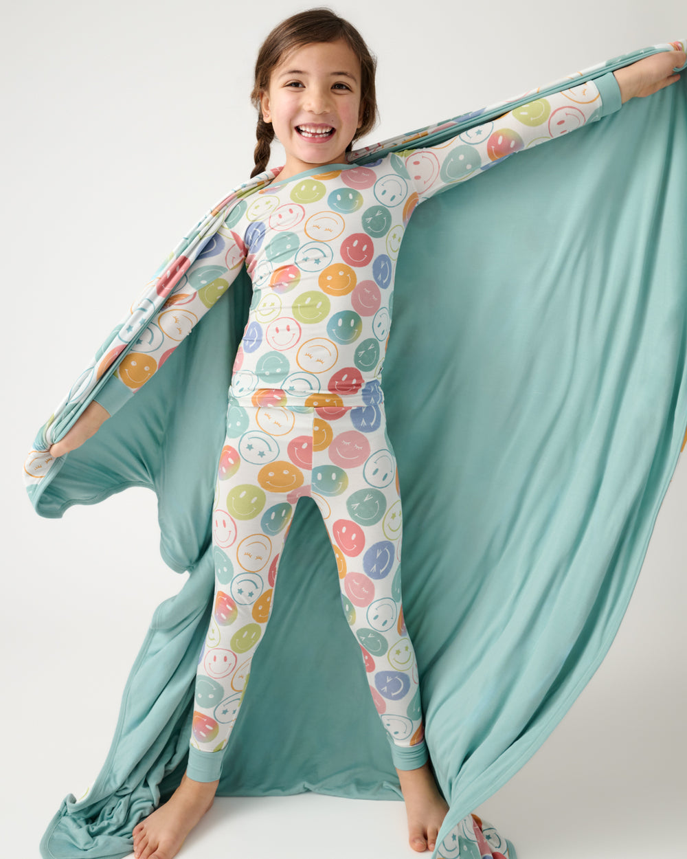 Girl holding the Positive Vibes Large Cloud Blanket® showing the solid blue side