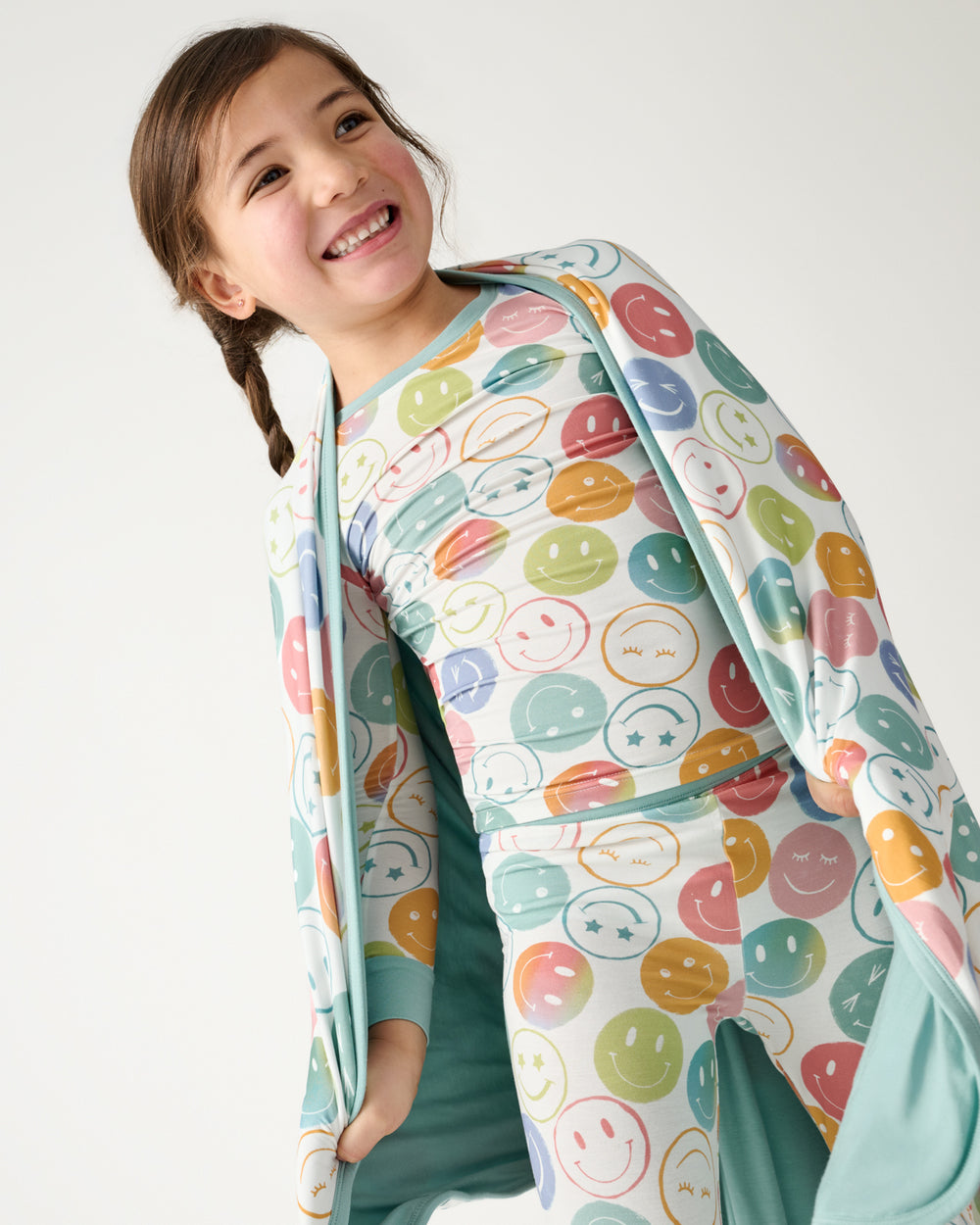Close up of girl with the Positive Vibes Large Cloud Blanket® draped over her shoulders