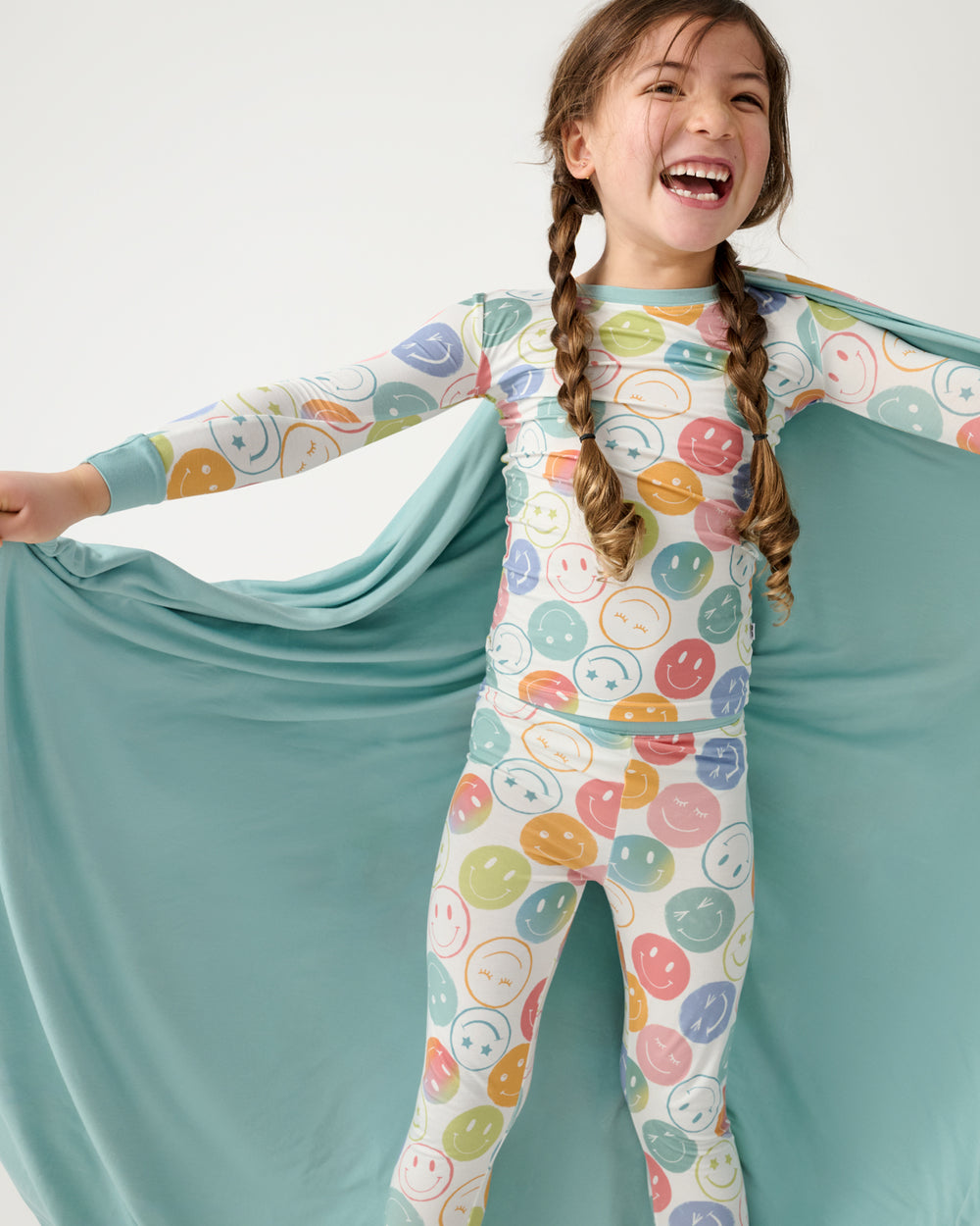 Close up of girl holding out the Positive Vibes Large Cloud Blanket®