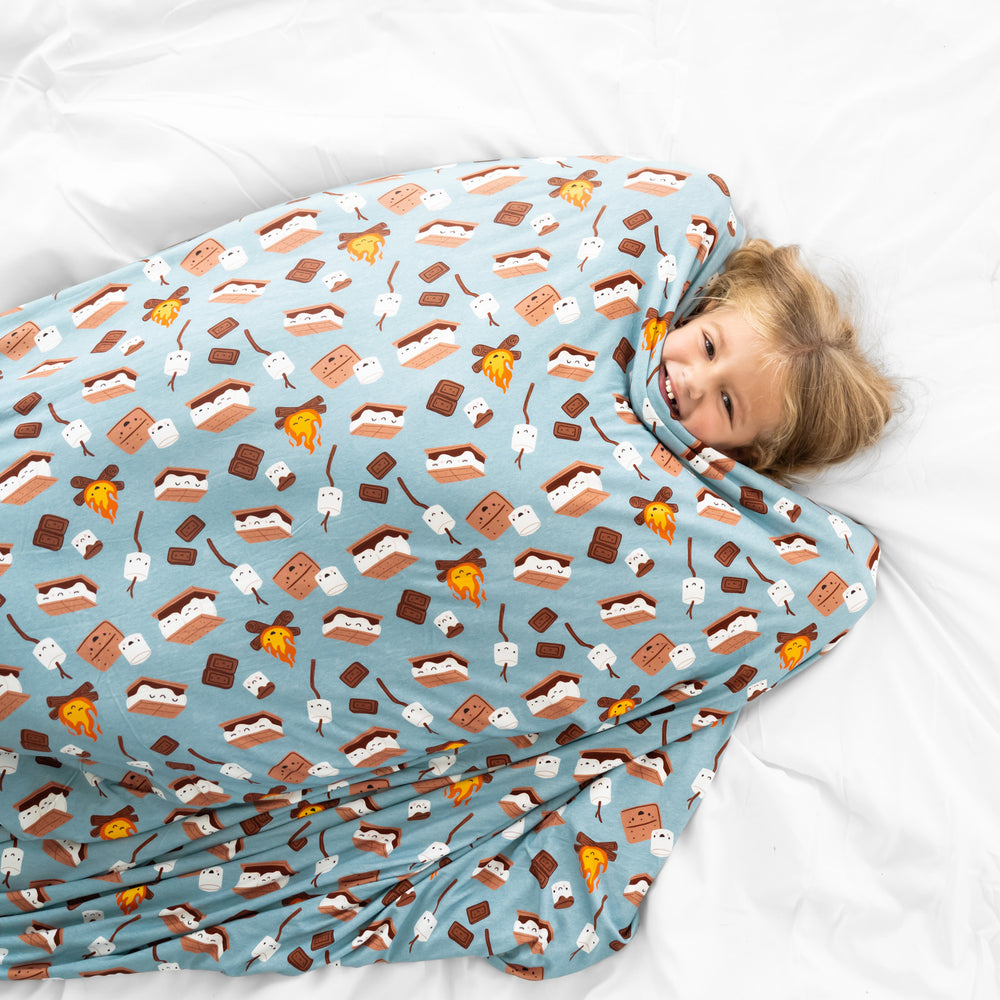 Child cuddled under a S'mores galore cloud blanket