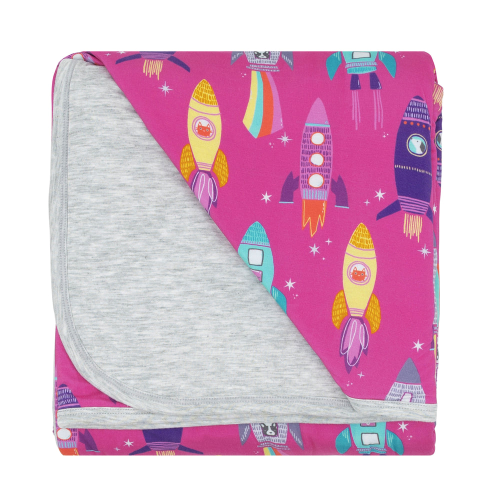 Flat lay image of a Pink Space Explorer cloud blanket showing the solid heather gray backing