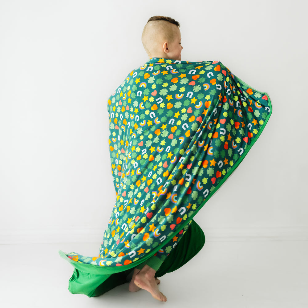 Back view of a child wearing a Lucky cloud blanket over his shoulders
