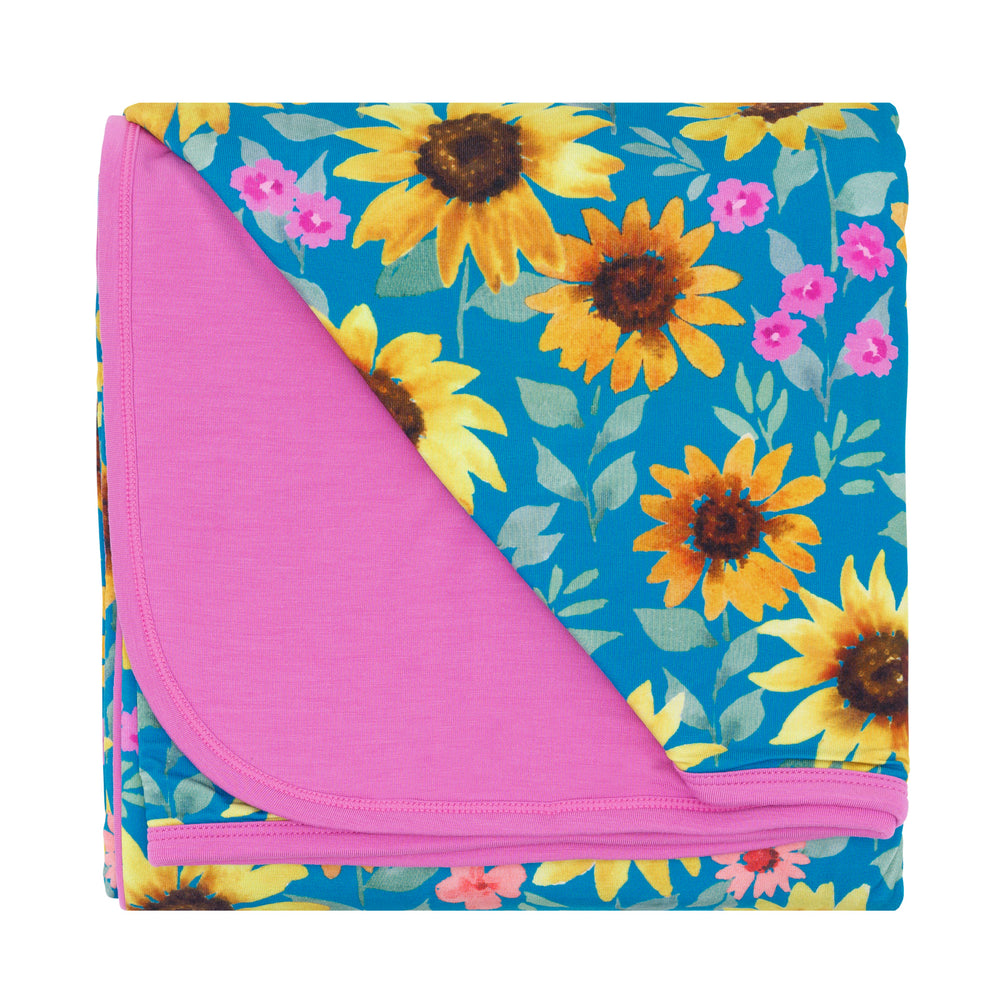 Flat lay image of the Sunflower Fields Large Cloud Blanket® folded