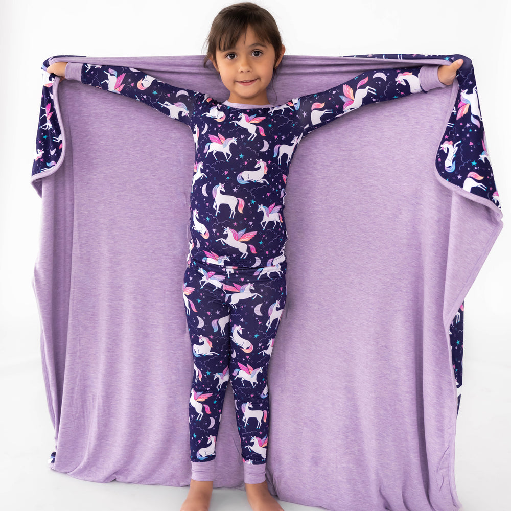 Child displaying the inside of the Magical Skies Large Cloud Blanket®