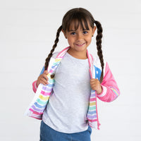 Girl wearing the Bluey Pink Bomber Jacket  displaying the inner stripe detail of the jacket
