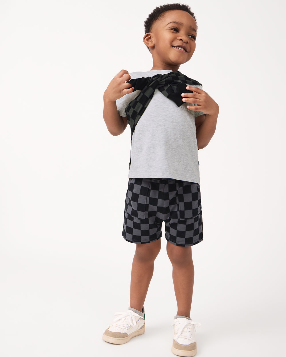 Boy wearing the Monochrome Checks Shorts with a gray tshirt