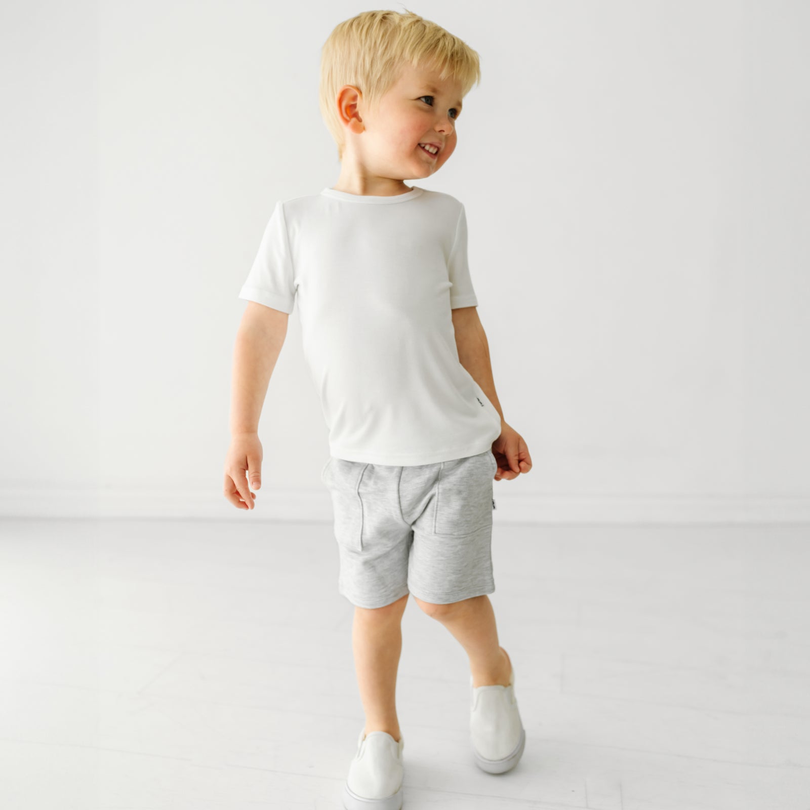 Child wearing Light Heather Gray shorts and coordinating Play top