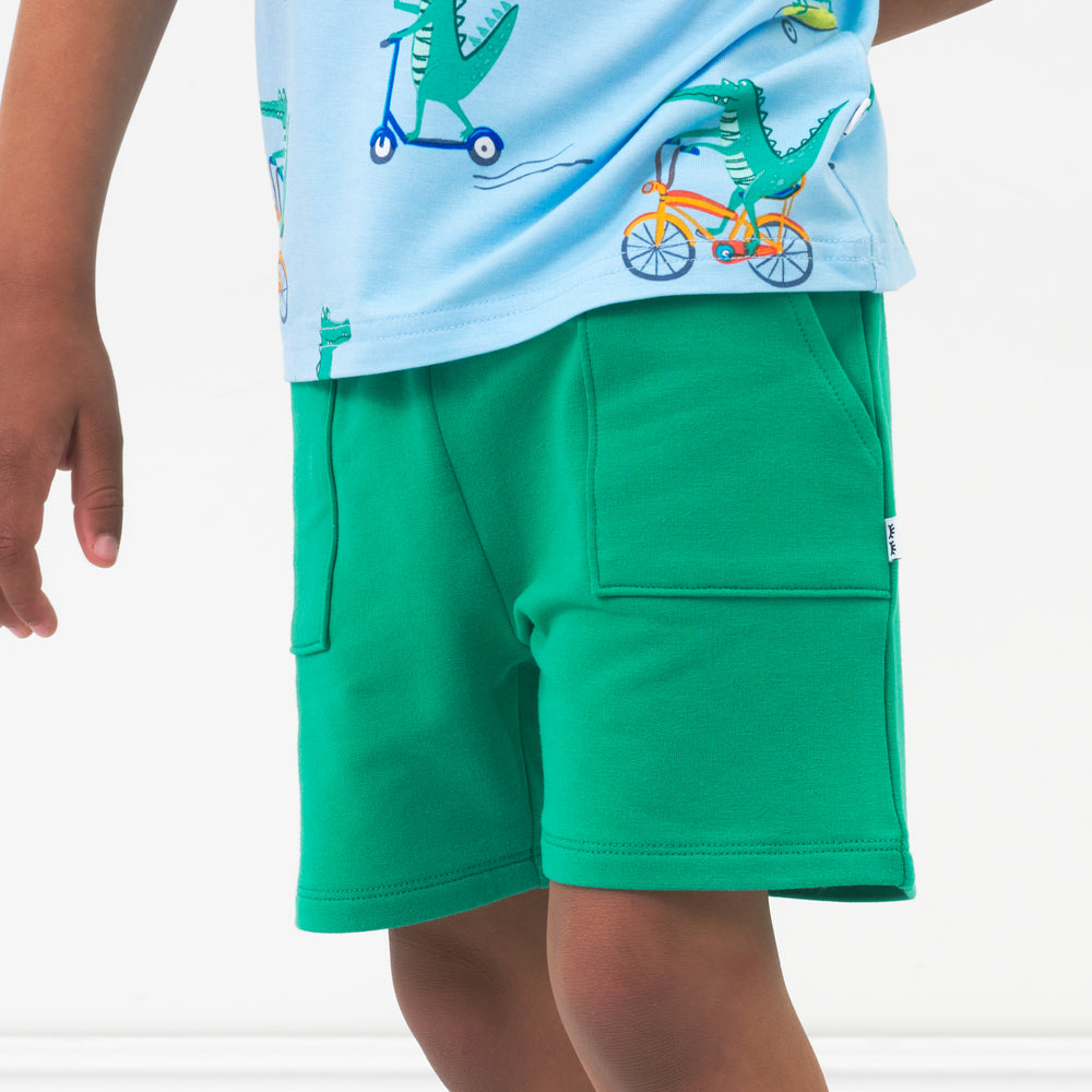 Close up image of a child wearing Marine Green shorts and coordinating top