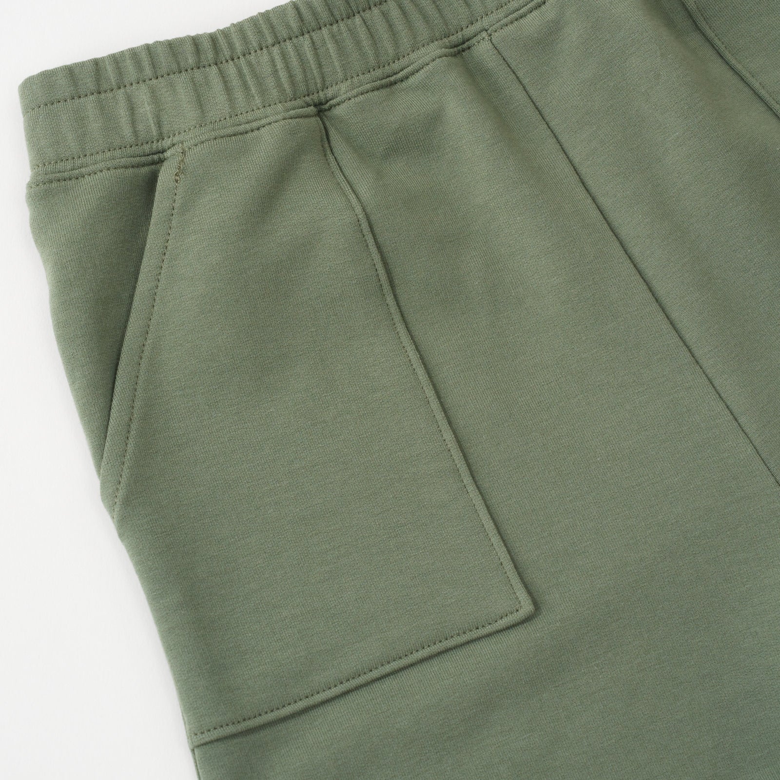 Close up flat lay image of the side pocket and waist details on the Moss Shorts