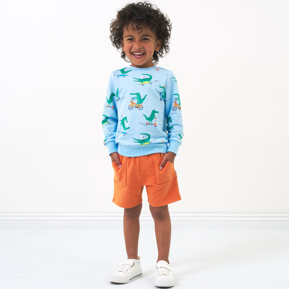 Alternate image of a child wearing Rust Orange shorts and coordinating crewneck sweatshirt