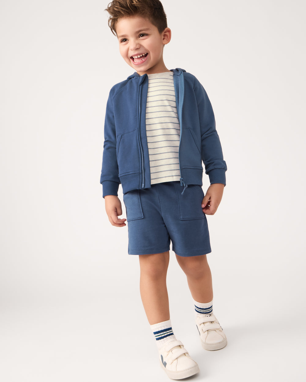 Boy wearing the Vintage Navy Zip Hoodie and Shorts