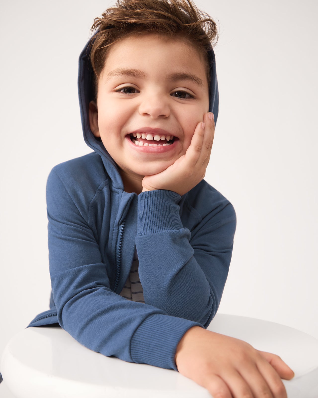 Close up of boy wearing the Vintage Navy Zip Hoodie with the hood on