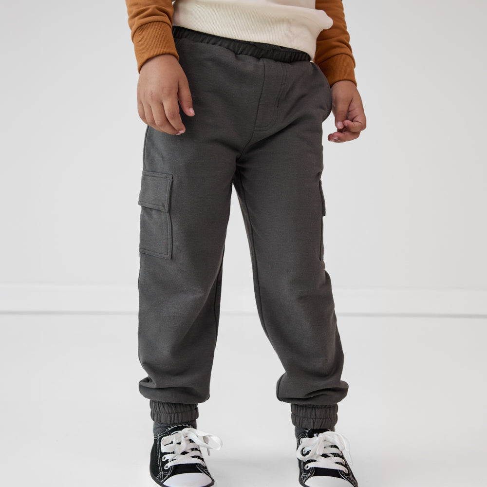 Close-up view of a child wearing Washed Black cargo joggers