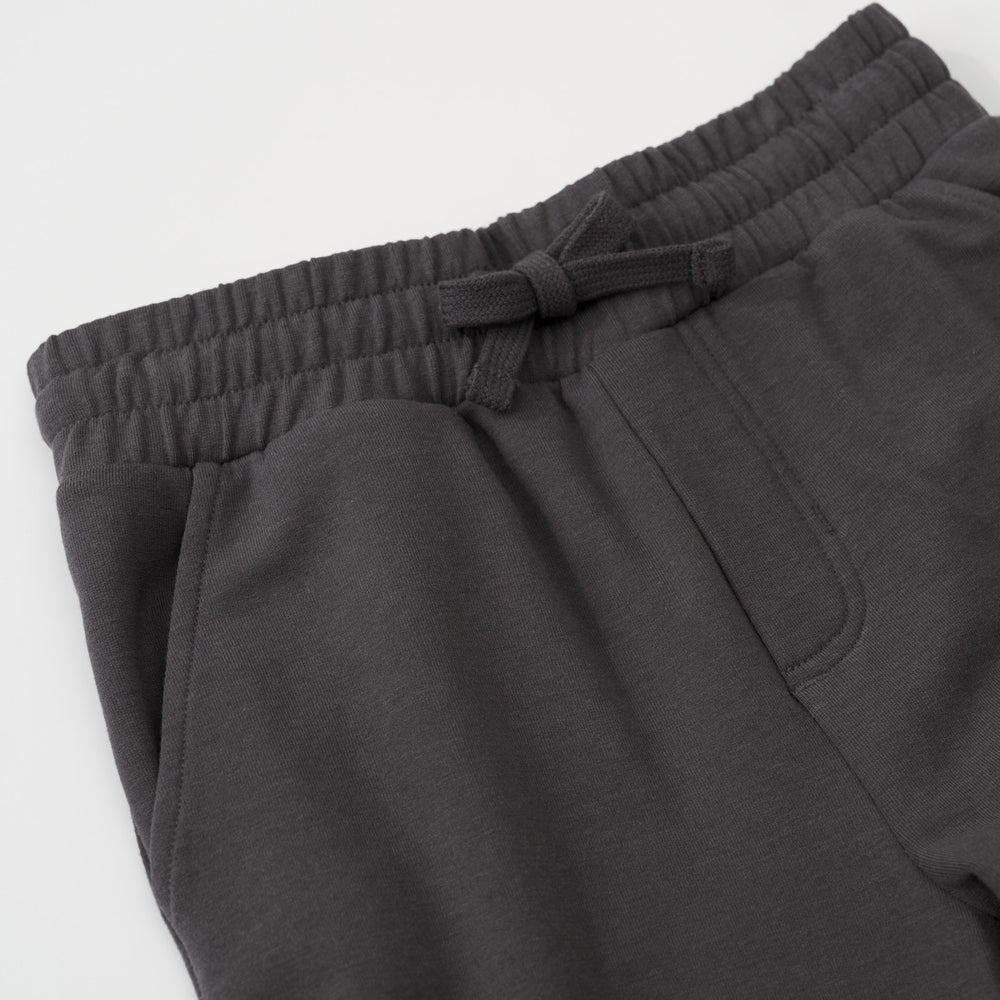 Close-up view of the drawstring waist and pockets on a Washed Black cargo jogger