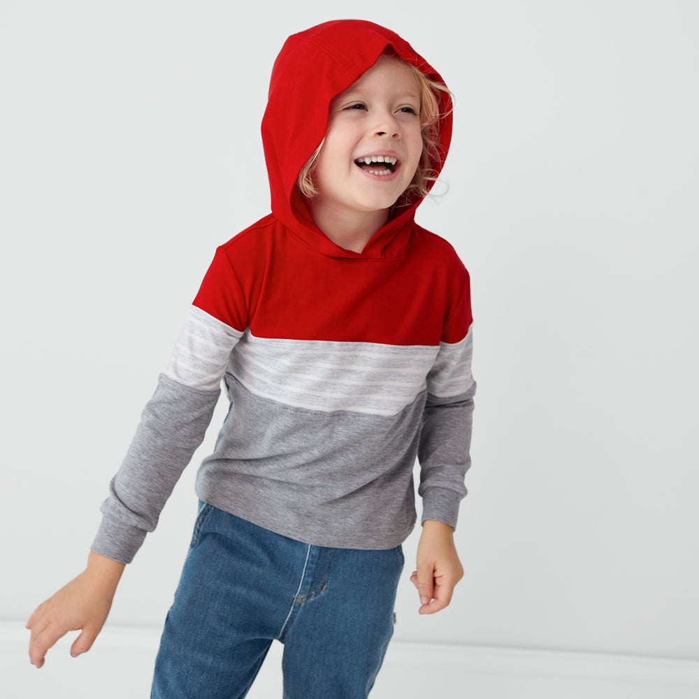 Laughing child wearing a Candy Red Colorblock Hooded Tee with the hood up