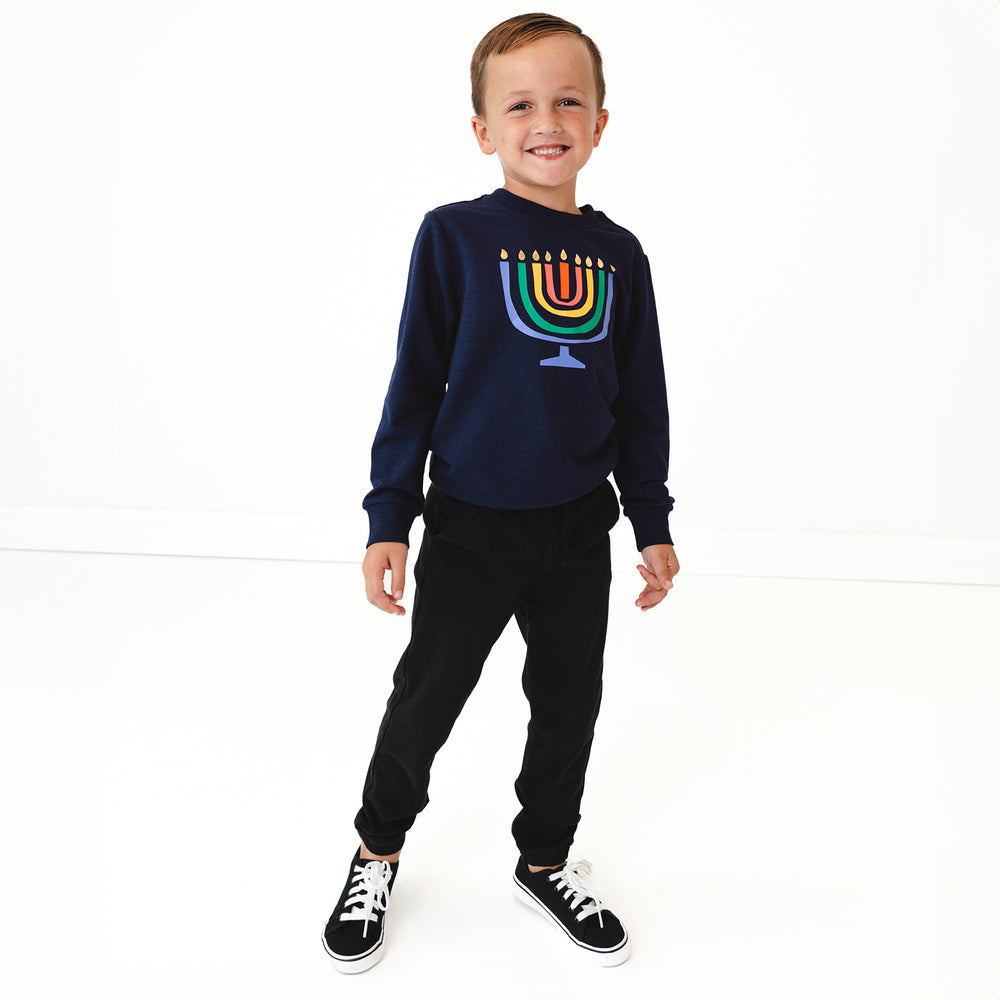 Child wearing a Menorah Graphic Crewneck and Black Denim Joggers