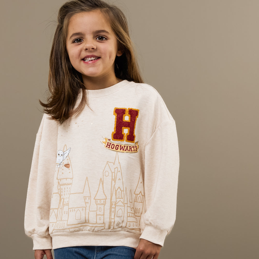 Close up image of a child wearing a Harry Potter Drop Shoulder Crewneck