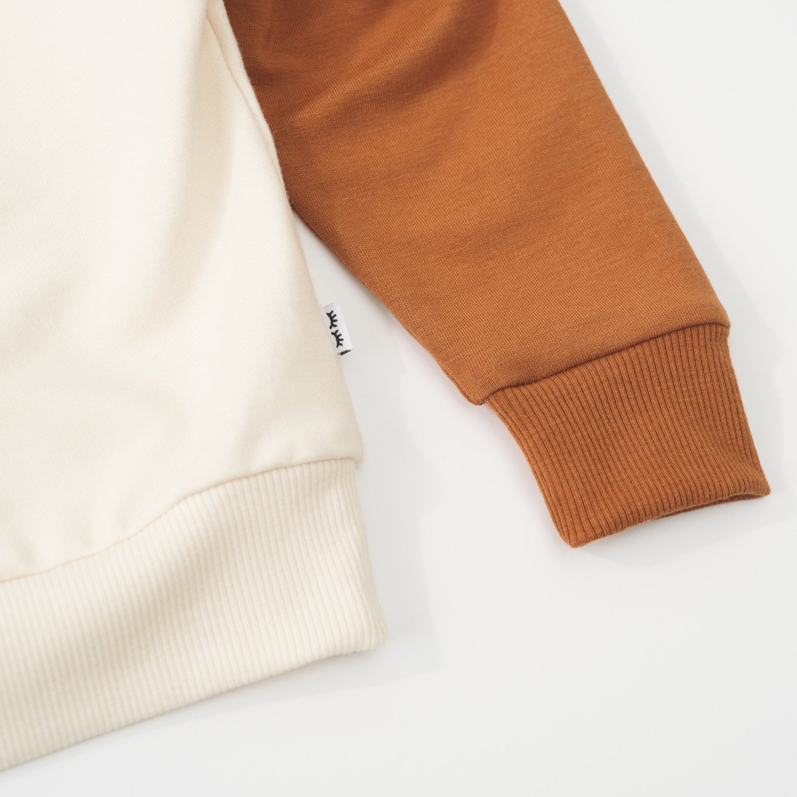 Close-up view of the sleeve cuff and hem on an Arctic raglan crewneck