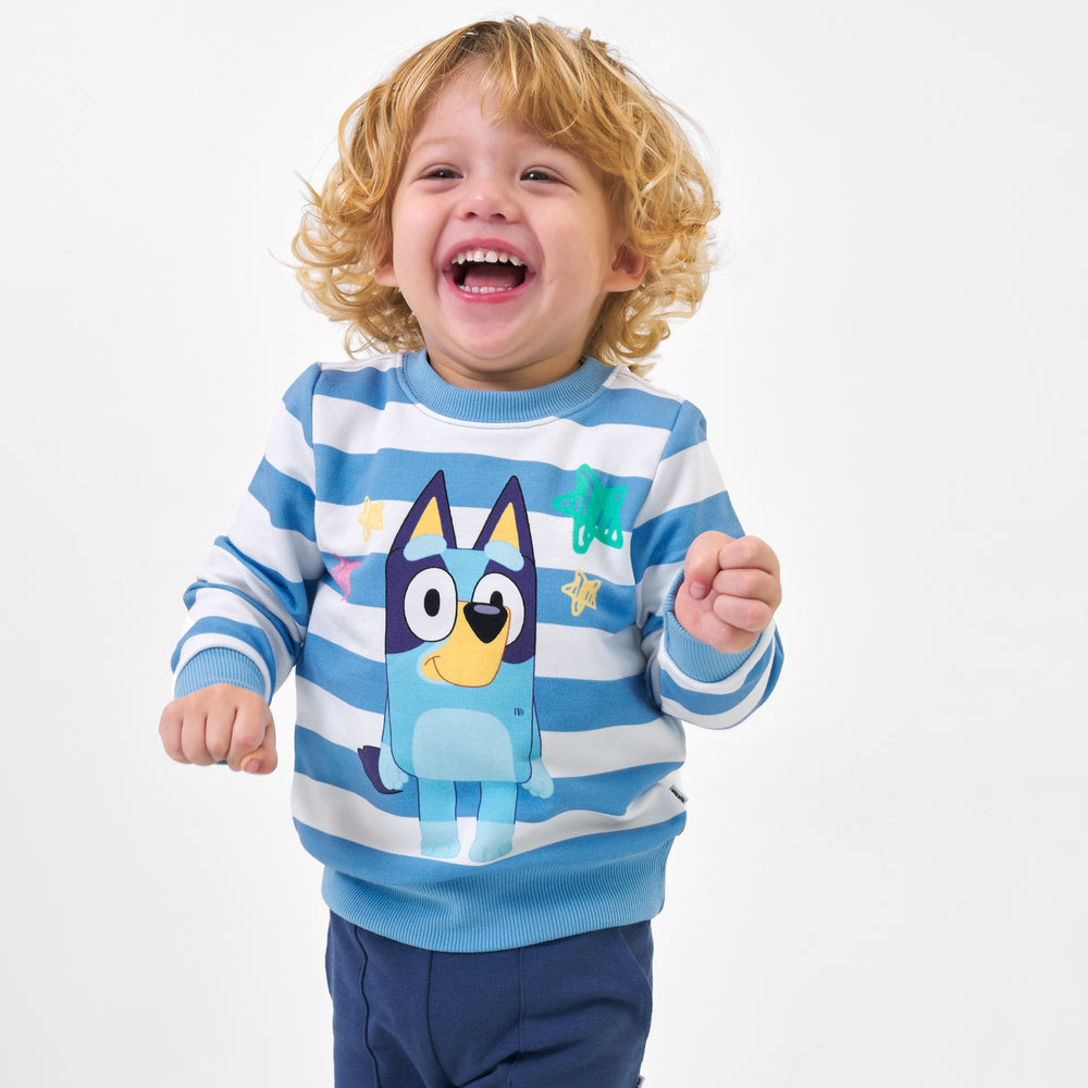 Child wearing a Bluey multi graphic crewneck sweatshirt and coordinating joggers