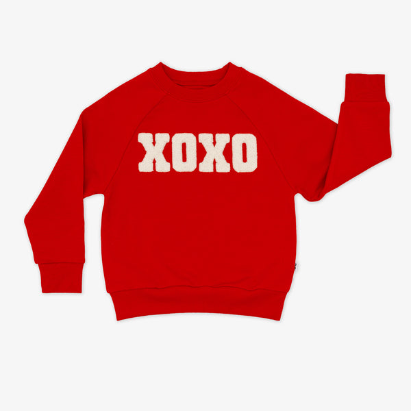 Flat lay of a red XOXO Crewneck Sweatshirt