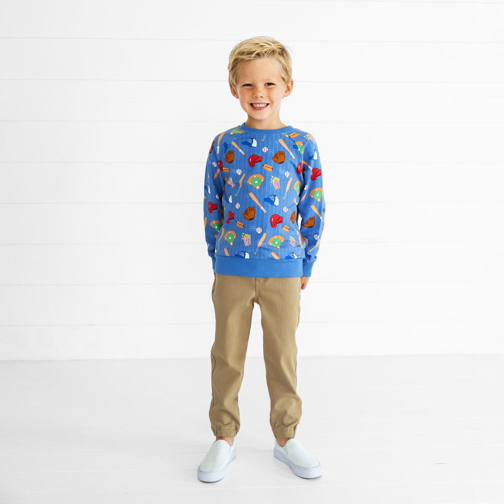 Image of a child wearing a Blue All Stars Crewneck Sweatshirt and Toasted Hazelnut Denim Jogger