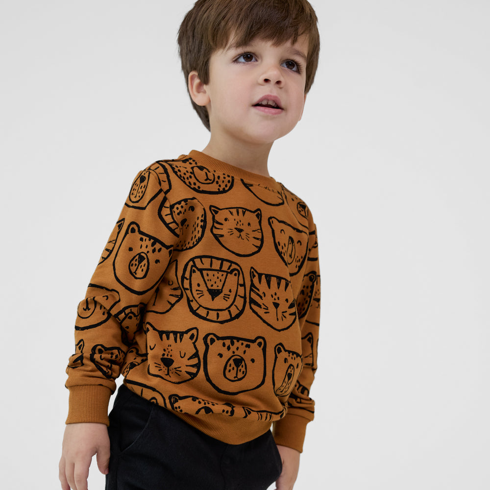 Child wearing an Amber Lions, Tigers & Bears crewneck sweatshirt with black animal illustrations