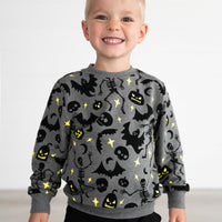 Boy smiling while wearing the Gray Glowing Ghouls Crewneck Sweatshirt