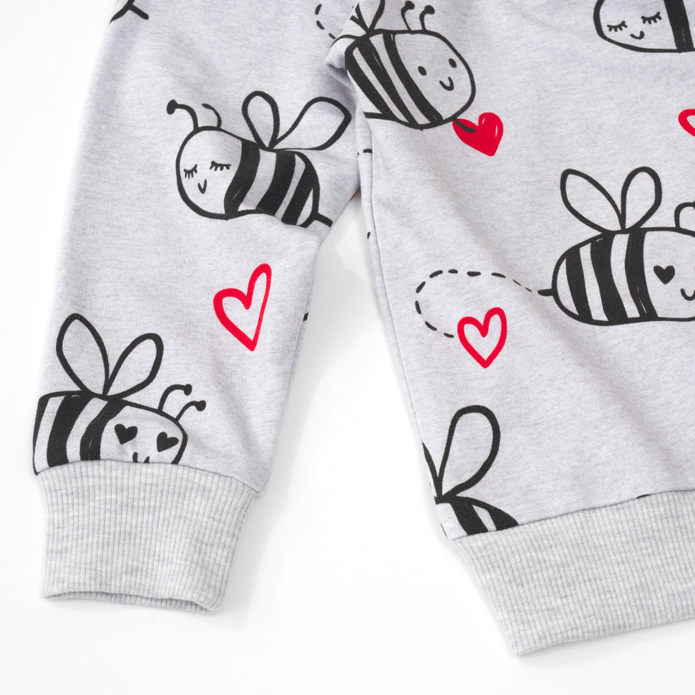 close up view of the sleeve cuff and bottom hem of a bee mine crewneck sweatshirt