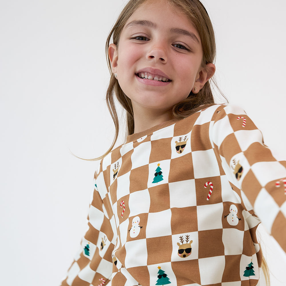 Close up image of a child wearing a Holiday Checks Crewneck Sweatshirt