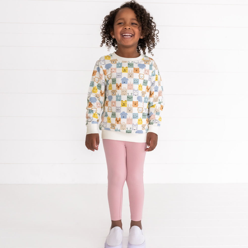 Image of a child wearing a Check Mates Crewneck Sweatshirt and Mauve Blush Legging