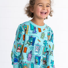 Alternative close up image of smiling girl wearing the Disney Monsters, Inc. Scream Team Crewneck Sweatshirt