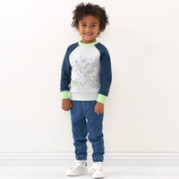 Child wearing a Disney Pixar Buzz Lightyear crewneck sweatshirt and coordinating bottoms