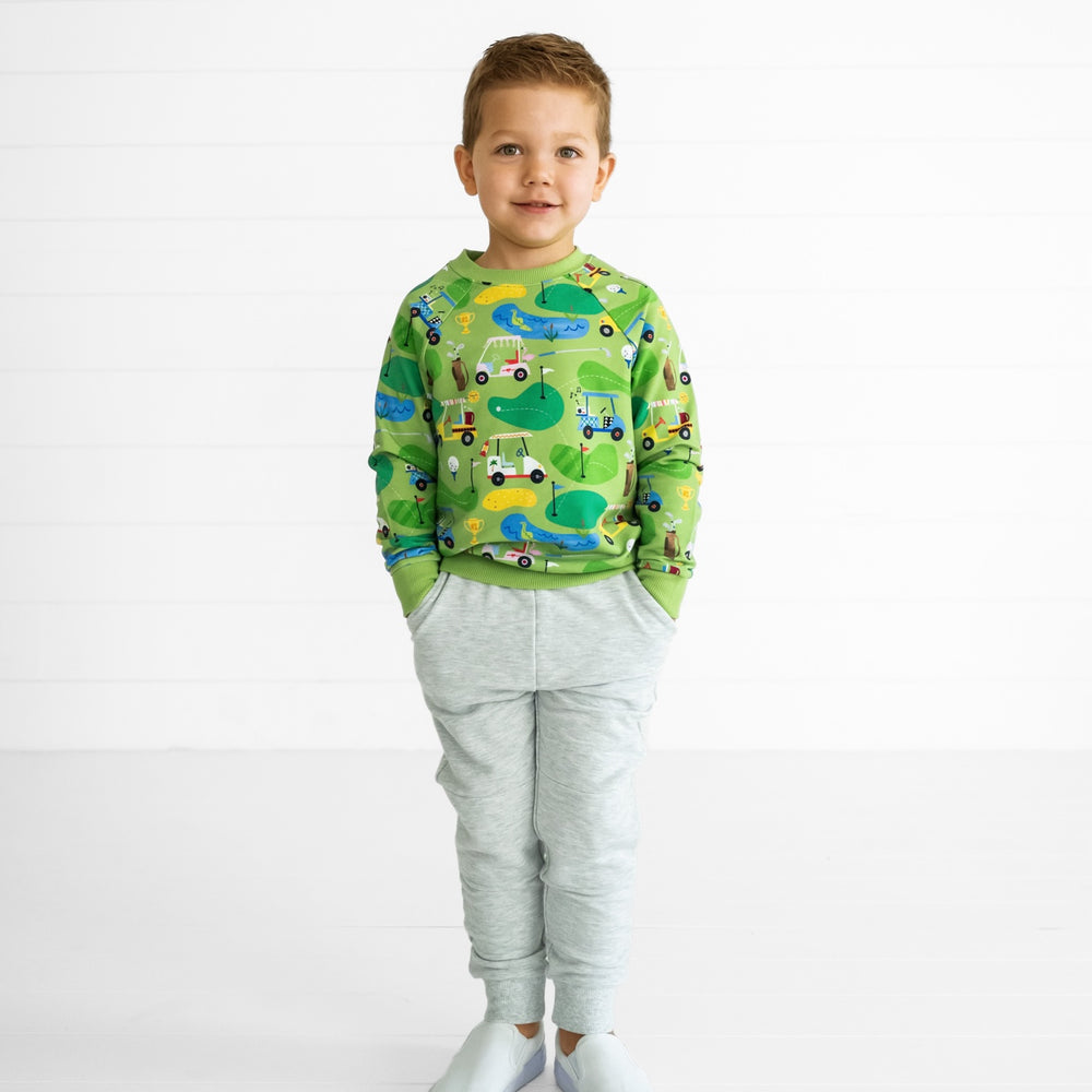 Image of a child wearing a Fairway Fun Crewneck Sweatshirt and Light Heather Gray Jogger