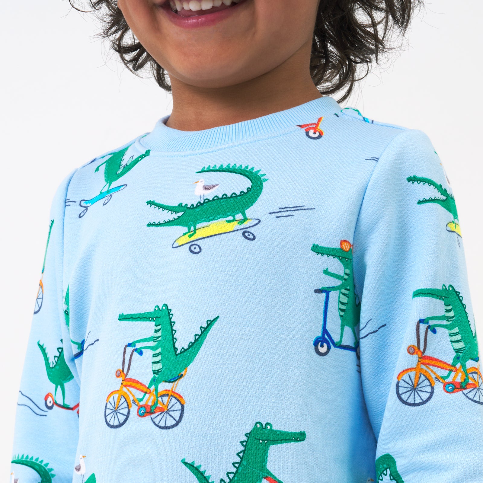 Close up image of a child wearing a Later Gator crewneck sweatshirt