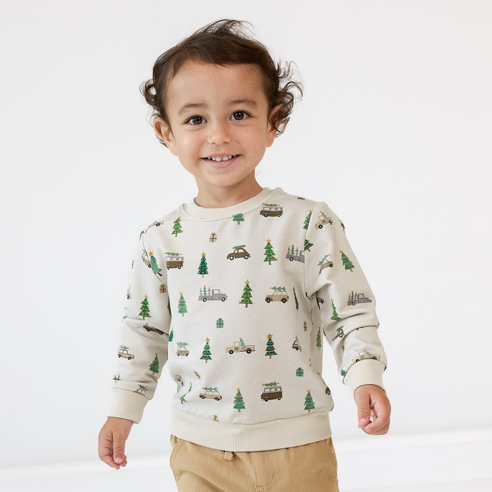 Close up image of a child wearing a Tree Traffic Crewneck Sweatshirt