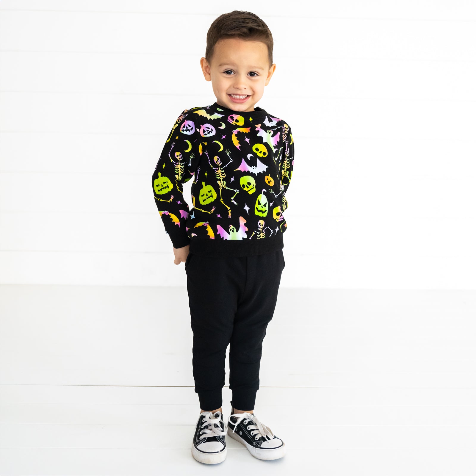 Child wearing a Cool Ghouls Crewneck Sweatshirt and Black Jogger