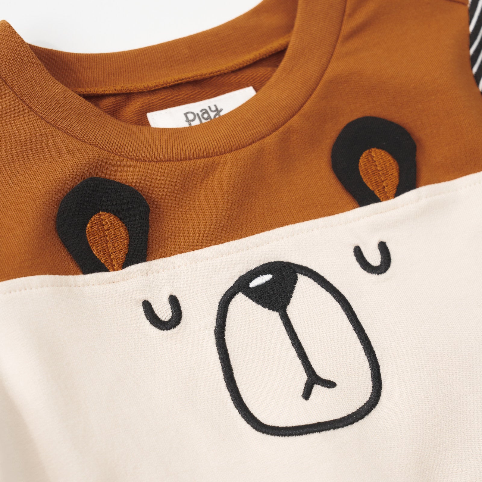 Close-up view of the bear face design on an Arctic Cinched Panel Crewneck