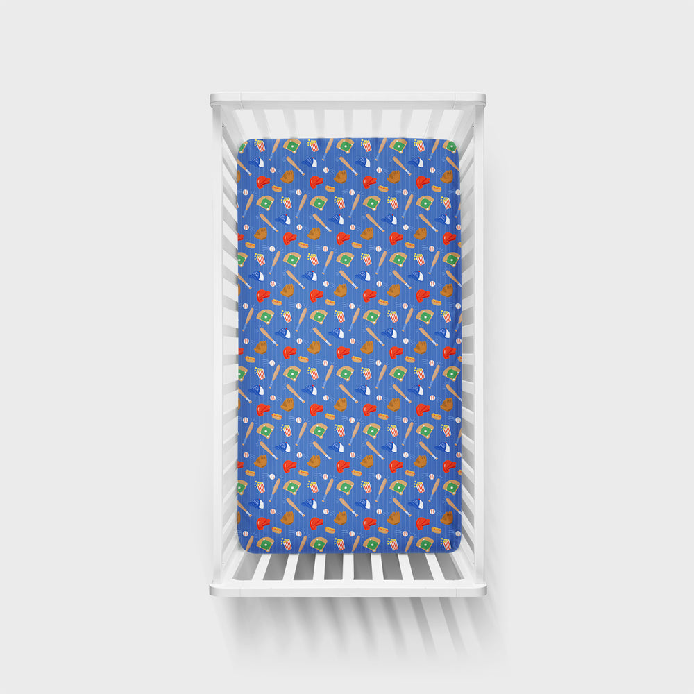 Top view of a Blue All Stars Fitted Crib Sheet in a white Crib