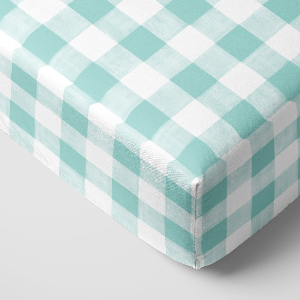Click to see full screen - Corner view of an Aqua Gingham fitted crib sheet