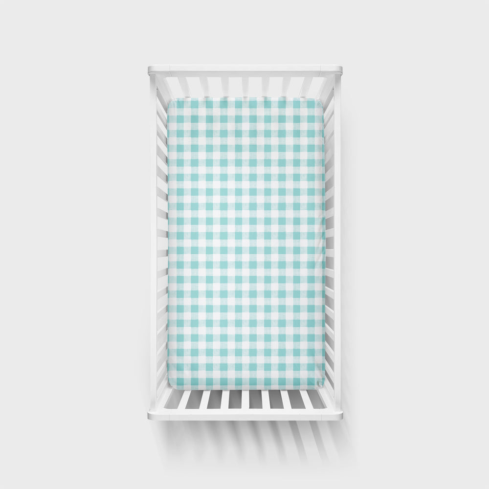Click to see full screen - Top view of Aqua Gingham fitted crib sheet in a white crib
