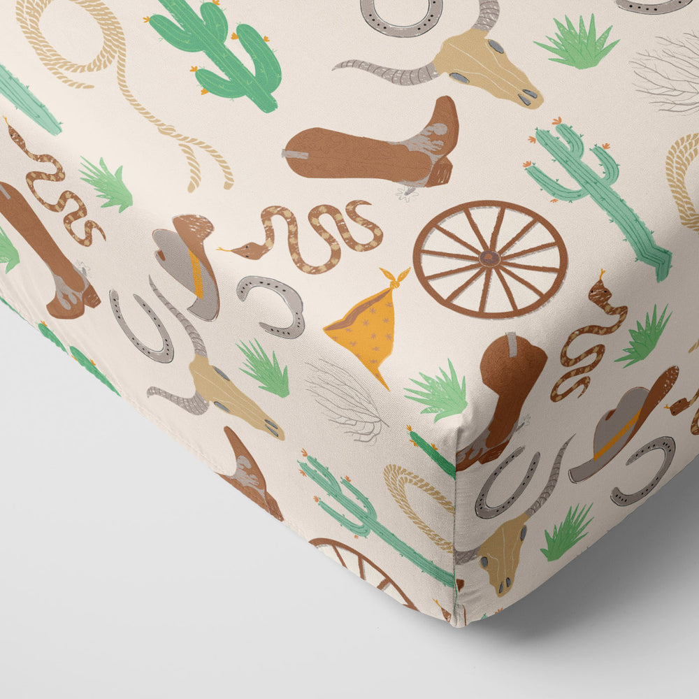 Corner image of Caramel Ready to Rodeo fitted crib sheet