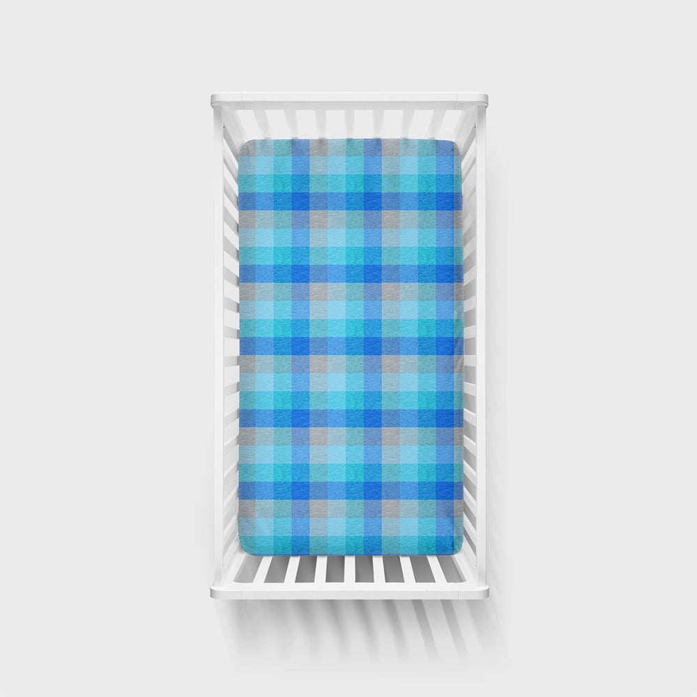 Arctic Plaid crib sheet in a white crib